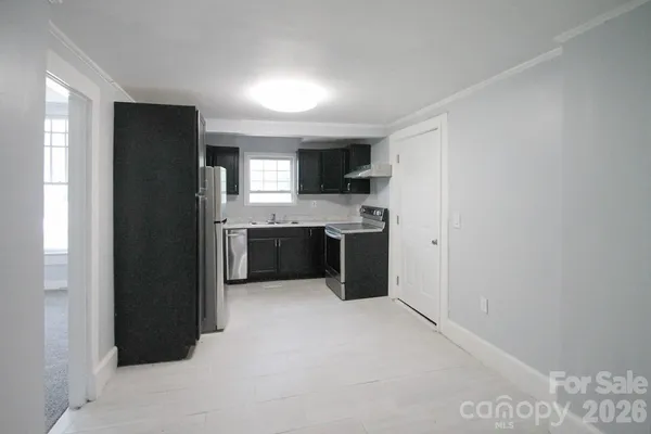 a kitchen with stainless steel appliances granite countertop a refrigerator and a sink