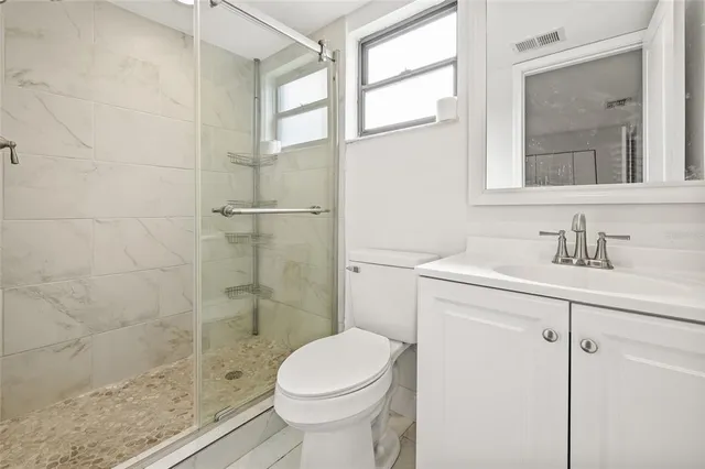a bathroom with a sink toilet and shower