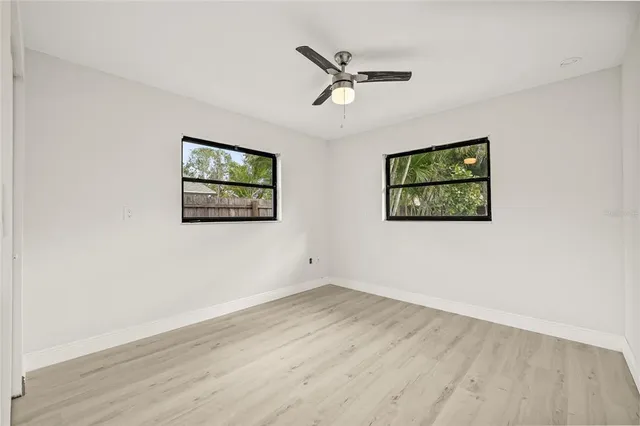 a view of empty room with wooden floor