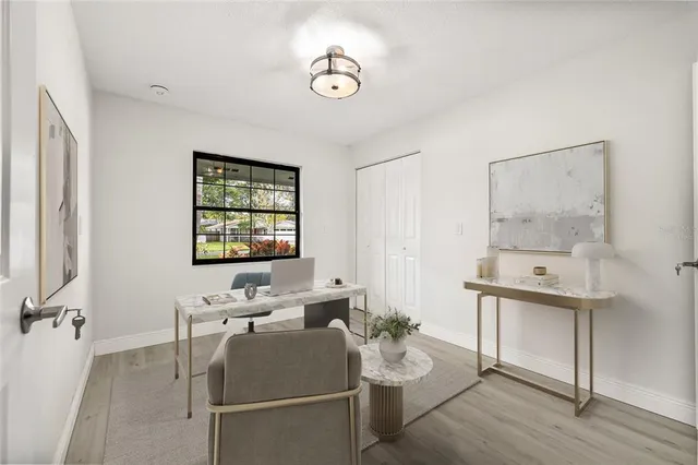 a living room with furniture and wooden floor