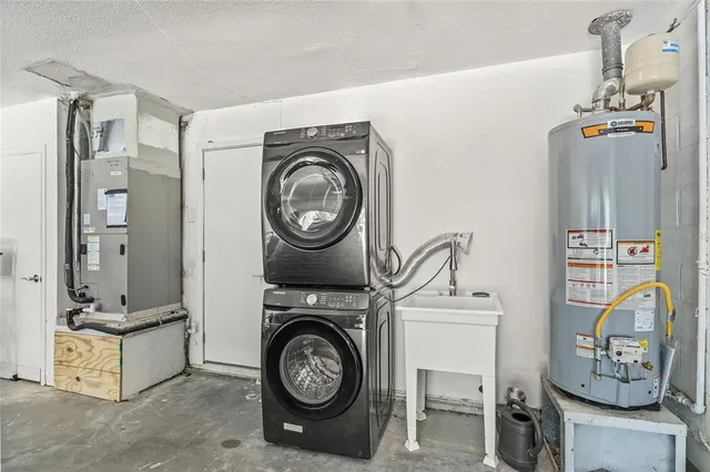 a utility room with sink dryer and washer