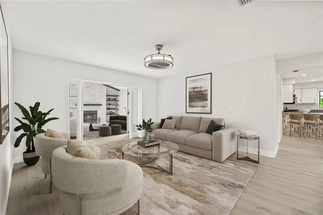 a living room with furniture potted plant and a window