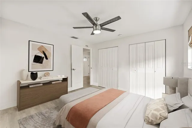 a bedroom with a bed and a chandelier