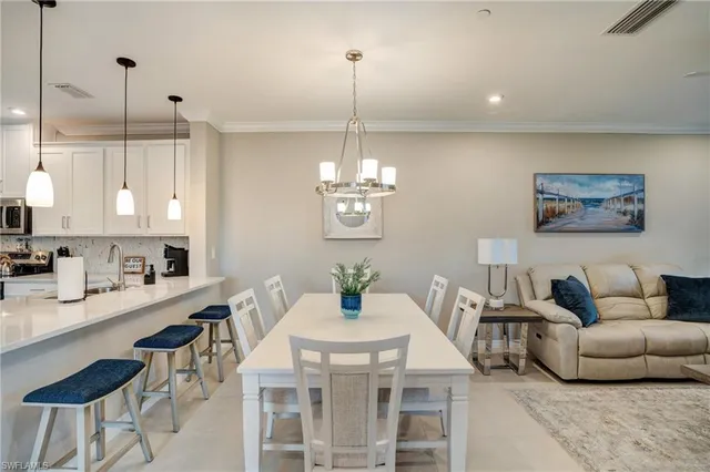 a living room with kitchen island furniture and a chandelier