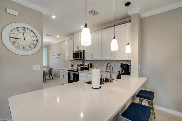 a large kitchen with a table and chairs