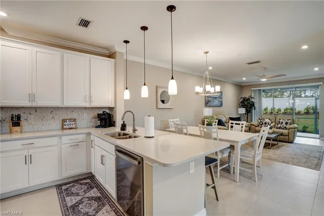 a kitchen with appliances a sink and cabinets