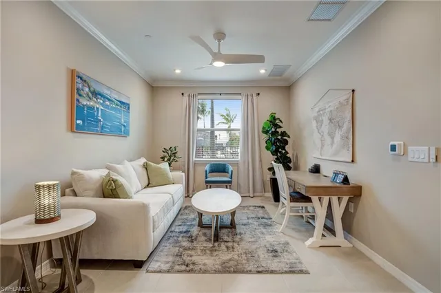 a living room with furniture a table and a potted plant