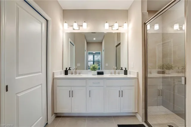 a bathroom with a double vanity sink and a mirror