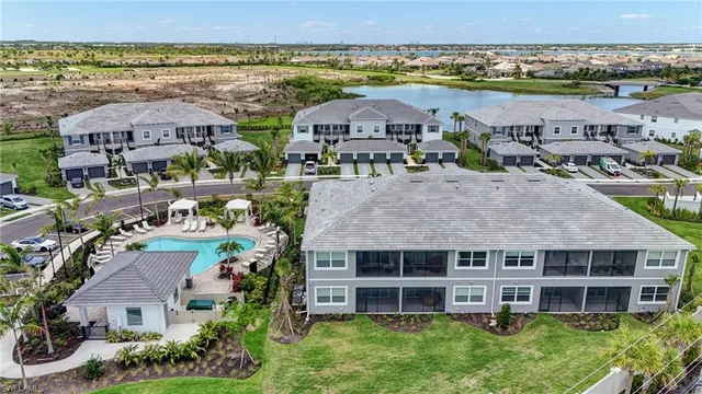 an aerial view of a house with a garden and lake view