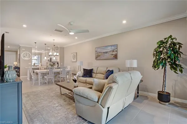 a living room with furniture and a potted plant