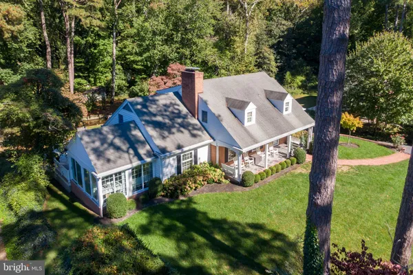 an aerial view of a house with big yard