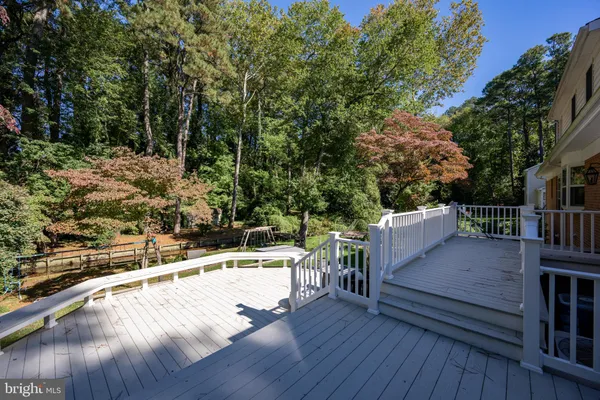 a view of a roof deck with wooden floor and fence