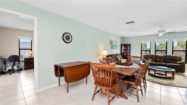 a living room with furniture a rug and a bookshelf