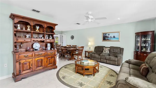 a kitchen with stainless steel appliances a microwave a stove a table and chairs