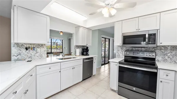 a kitchen with a sink stove and microwave