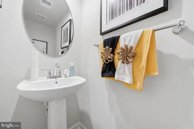 a bathroom with a sink and mirror
