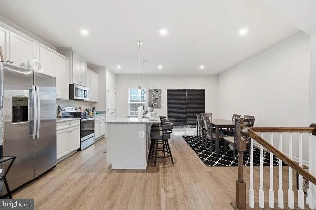 a kitchen with refrigerator and microwave