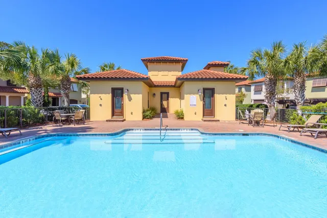 a view of a swimming pool with a table and chairs