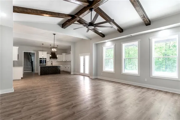 a view of a livingroom with a kitchen and a stove top oven