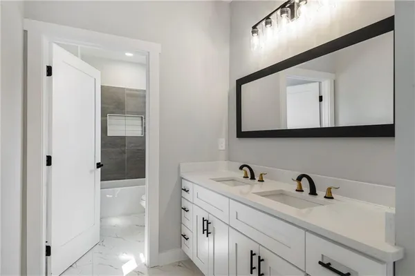 a bathroom with a sink a mirror and shower