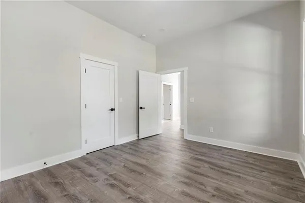 a view of an empty room with wooden floor