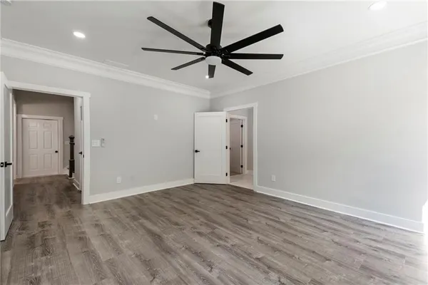 a view of empty room with wooden floor