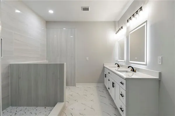 a bathroom with a double vanity sink and mirror