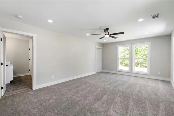 a view of a livingroom with a ceiling fan and window