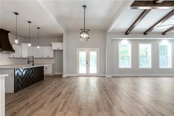 a view of a kitchen with a sink and wooden floor