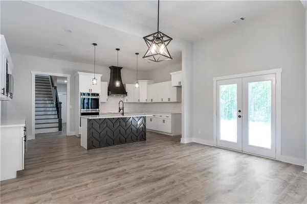 a view of a kitchen with wooden floor and windows