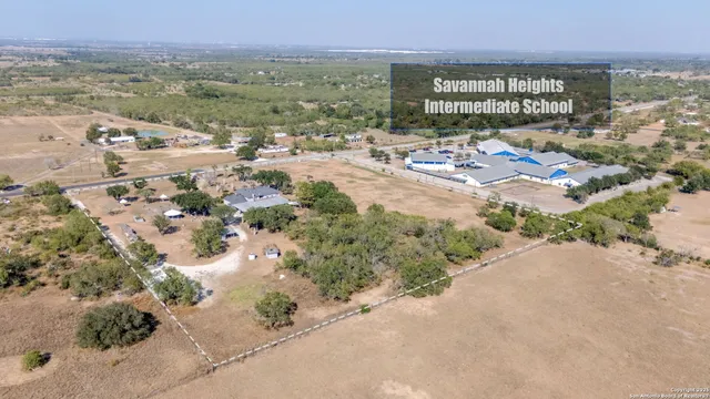 an aerial view of a house with garden space and lake view