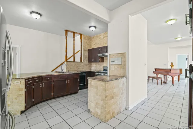a kitchen with stainless steel appliances granite countertop a stove sink and cabinets