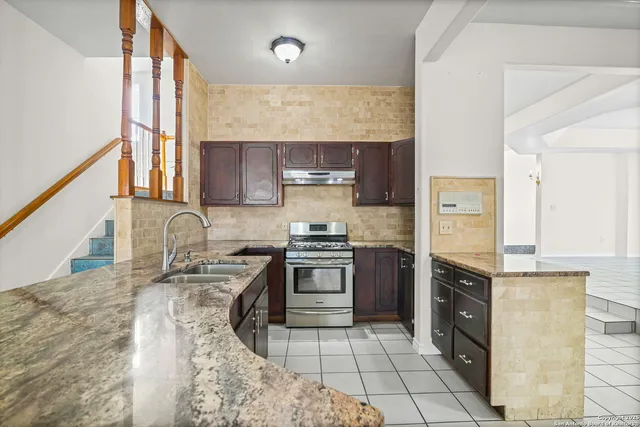 a spacious bathroom with a granite countertop sink and a mirror