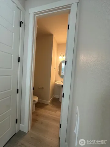 a bathroom with a granite countertop toilet and a shower