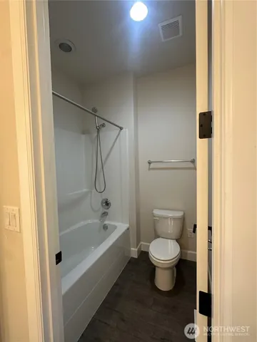 a view of storage and utility room with wooden floor