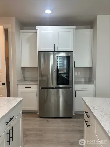 a kitchen with a refrigerator a stove a sink and a microwave