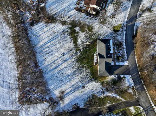 a view of a house with a yard covered with snow