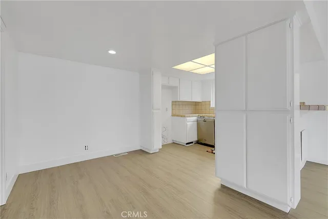 a view of a kitchen with a sink and a refrigerator
