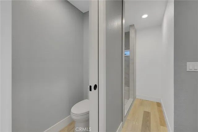 a bathroom with a granite countertop toilet and a sink