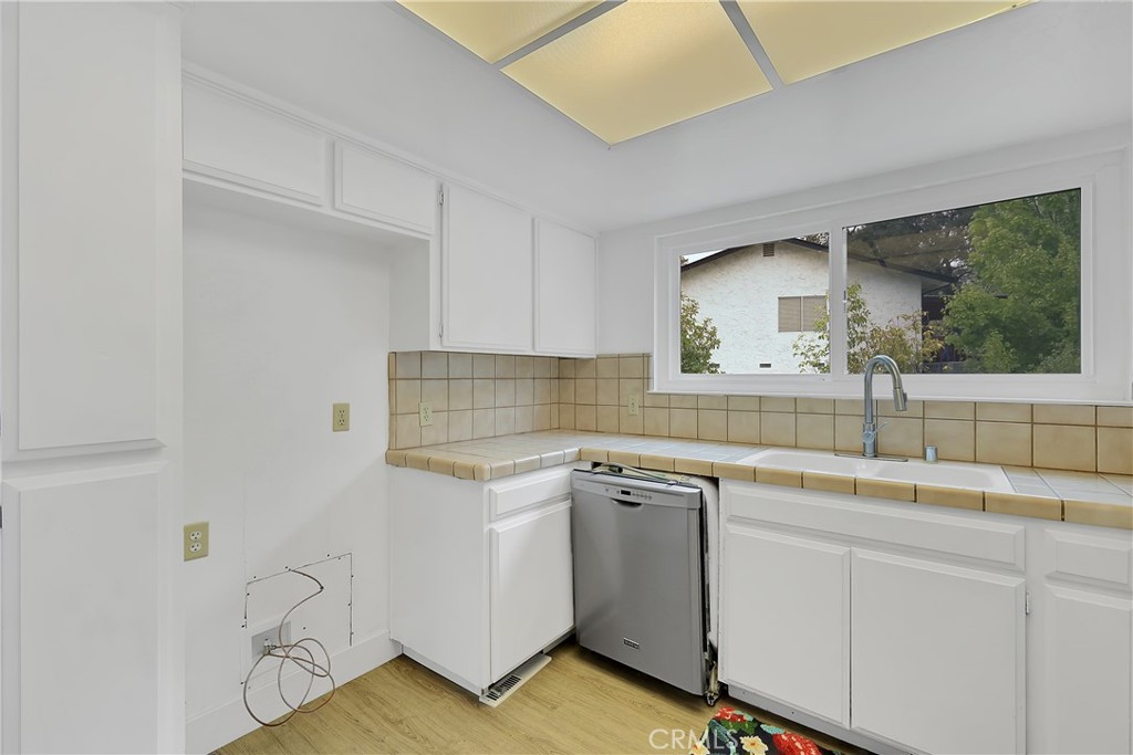 75 Lariat Loop Oroville, CA 95966 - Photo 32 of 47 a kitchen with a sink cabinets and wooden floor