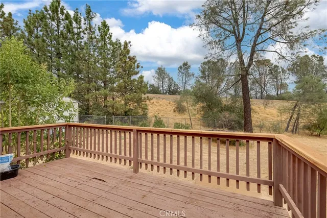 a view of balcony with wooden floor and fence