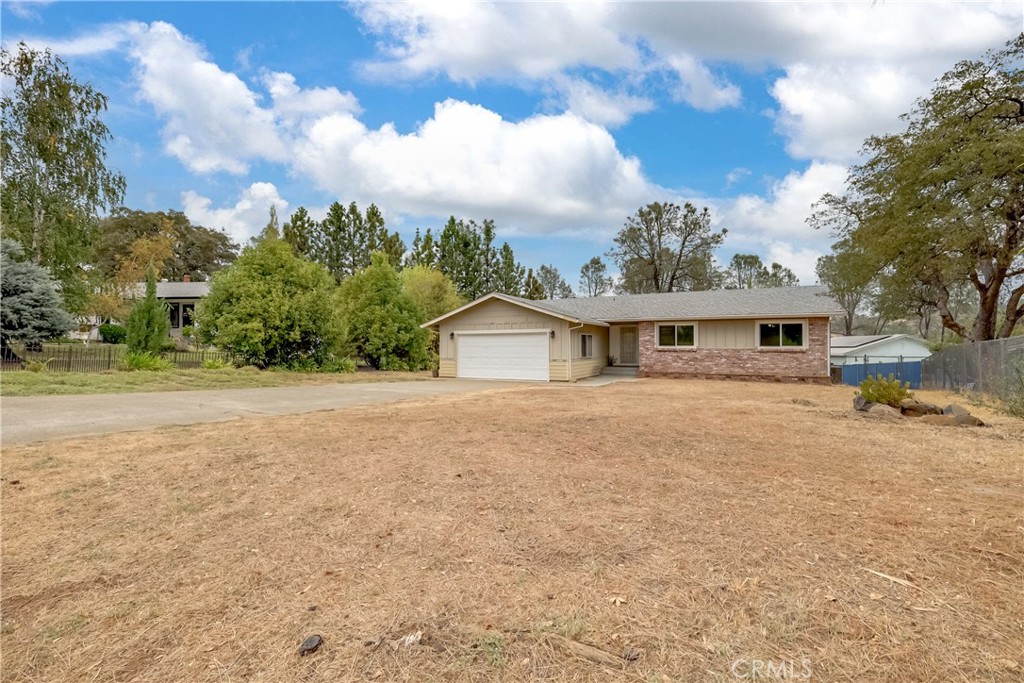 75 Lariat Loop Oroville, CA 95966 - Photo 44 of 47 a front view of a house with a yard and garage