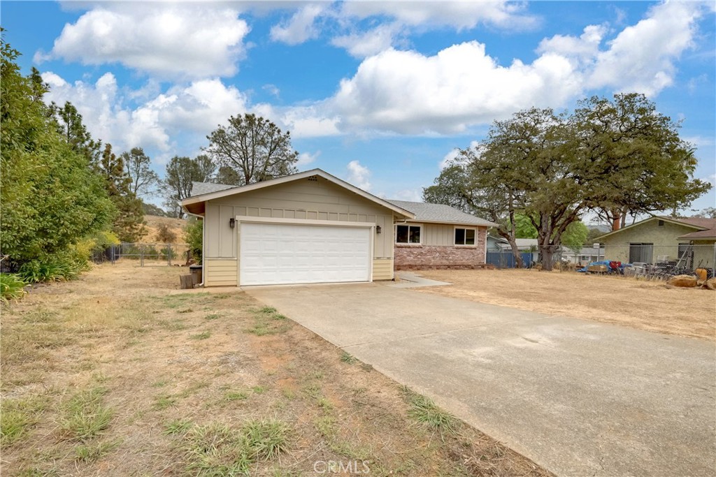 75 Lariat Loop Oroville, CA 95966 - Photo 46 of 47 a front view of a house with a yard and garage