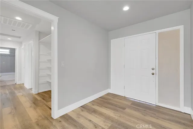 an empty room with wooden floor