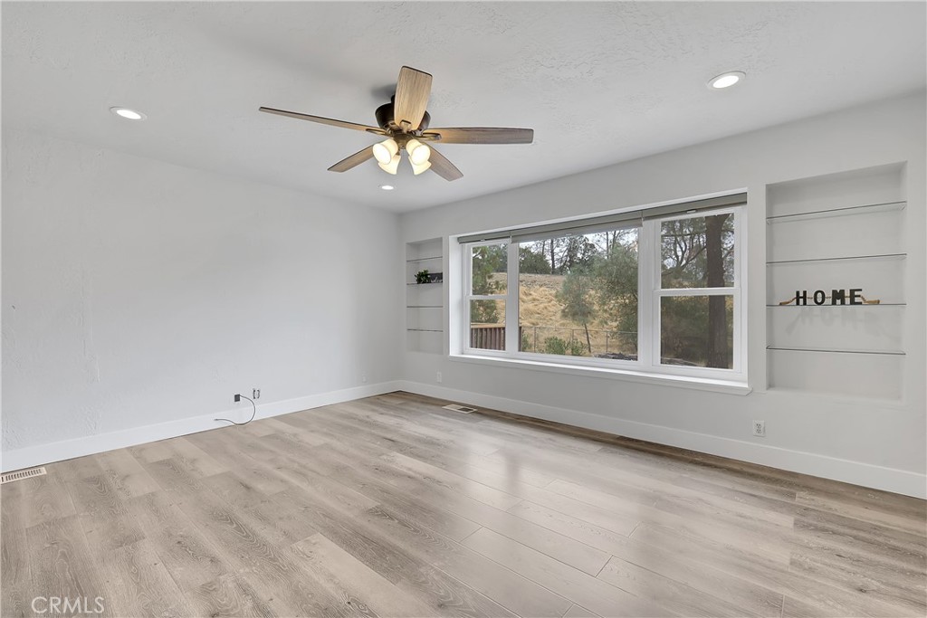 75 Lariat Loop Oroville, CA 95966 - Photo 7 of 47 an empty room with wooden floor fan and windows