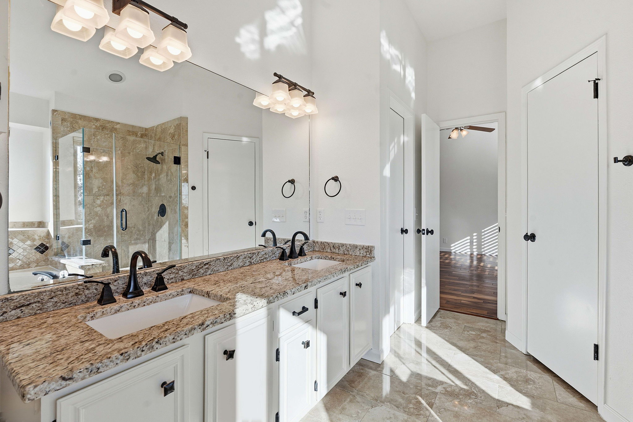 7801 Image Cove Austin, TX 78730 - Photo 12 of 26 a bathroom with a granite countertop double vanity sink mirror and shower