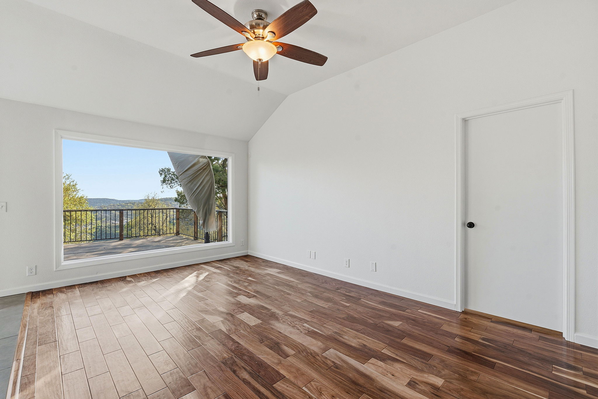 7801 Image Cove Austin, TX 78730 - Photo 15 of 26 wooden floor in an empty room with a window