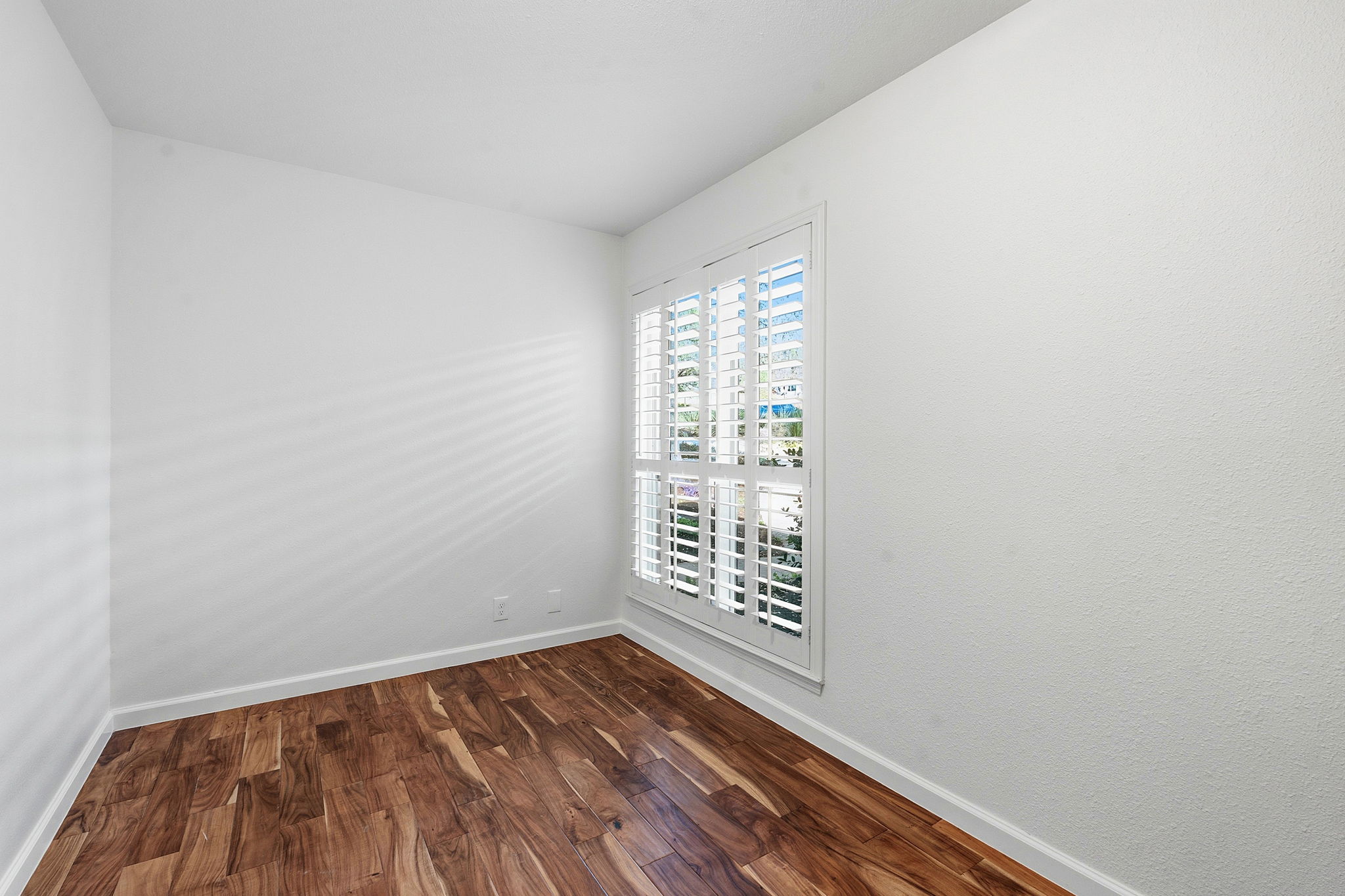 7801 Image Cove Austin, TX 78730 - Photo 17 of 26 a view of an empty room with wooden floor and a window