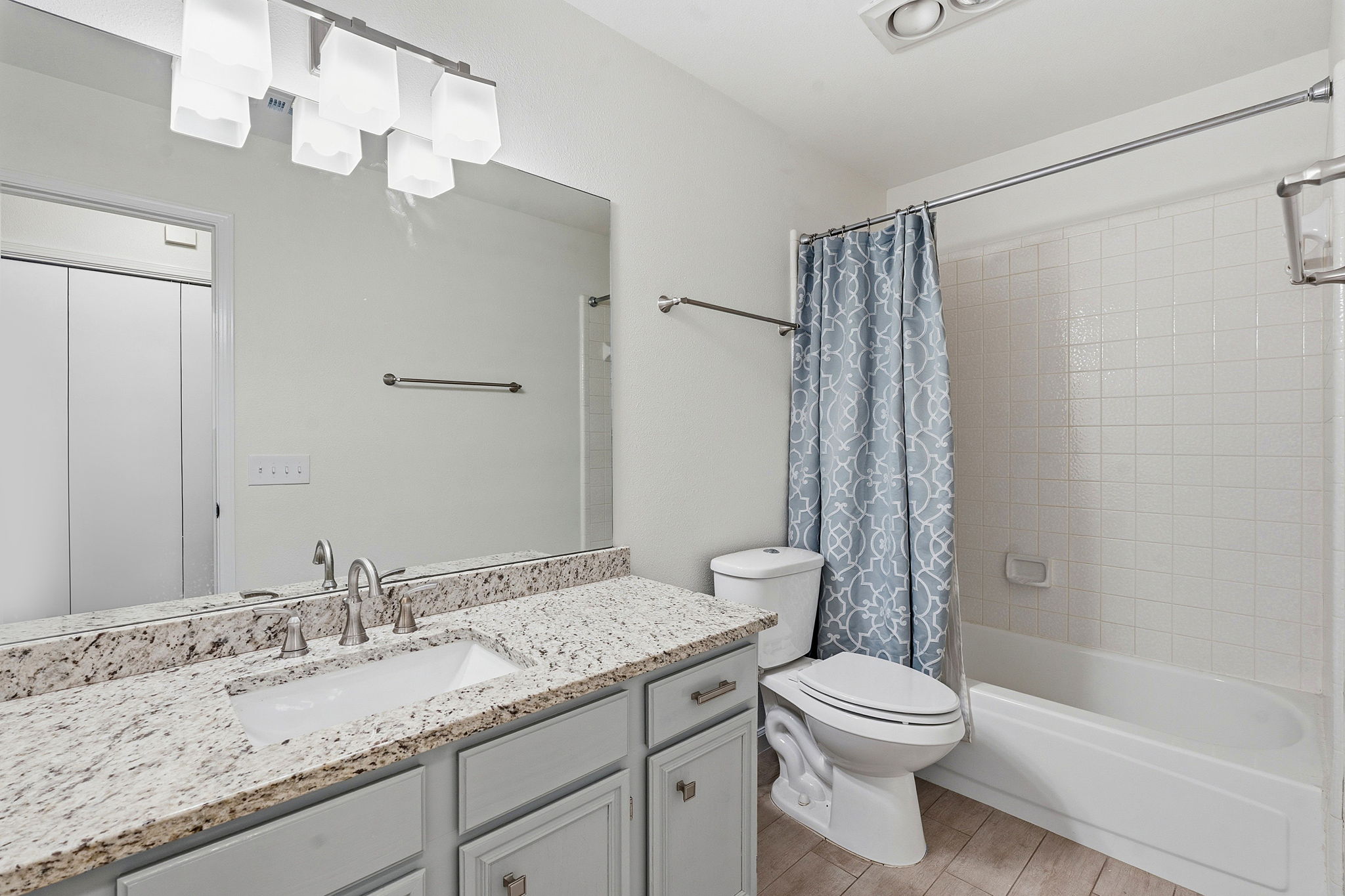 7801 Image Cove Austin, TX 78730 - Photo 18 of 26 a bathroom with a granite countertop sink a toilet and shower
