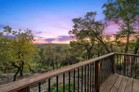 a view of a balcony with wooden fence